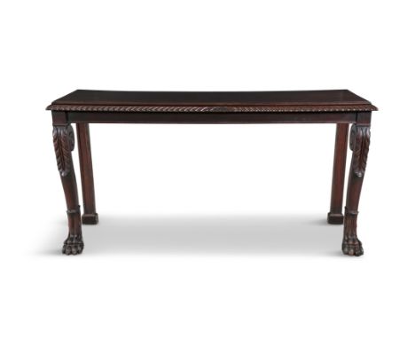 AN IRISH MAHOGANY CONSOLE TABLE, C.1830  the top with moulded rim above a gadrooned border, raised on scroll legs with acanth