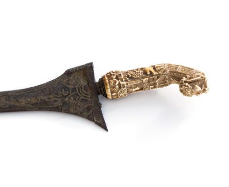 A Malaysian kris dagger, 19th Century or earlier, carved ivory hilt, damascus steel blade, length 32cm, treen scabbard,