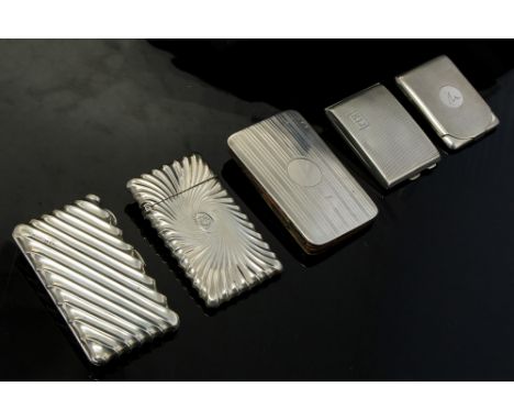 A collection of five various silver calling card cases including: a Victorian rectangular wyvern fluted example, with oval ca