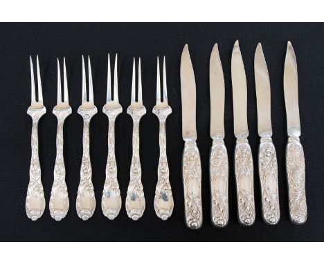 A Tiffany sterling silver fruit knife and fork part set, comprising six forks and five knives, all with foliage cast handles,