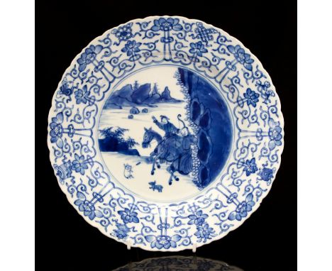 A Chinese blue and white Kangxi period 1662-1722 dish, painted with two equestrian figures hunting in a landscape with overha