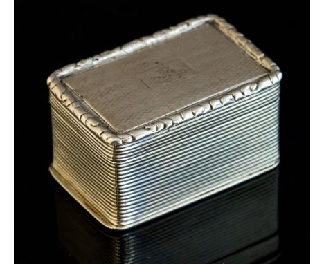 A George IV silver nutmeg grater, rectangular with engine turned decoration, the hinged cover engraved with a crest within re