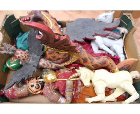 A box containing wooden puppet figures to include Dragons 