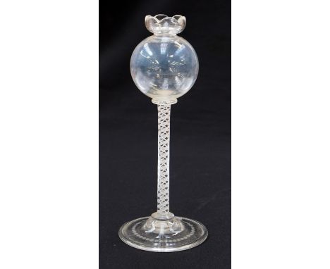 An 18th century opaque twist oil lamp, the spherical bowl on a multi strand ribbon and double helix core stem, 20cm high 