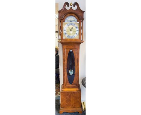 A Comitti modern longcase clock, having three brass cased weights, the dial with an eight day movement and three winder holes