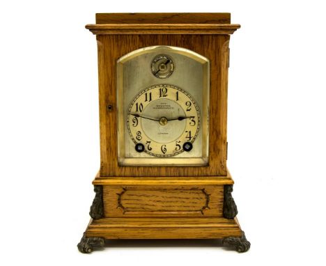 An early 20th Century Webster, London mounted clock with light oak case, silvered dial with chapter ring having Arabic numera
