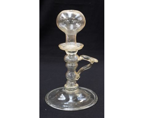 An 18th century glass lace-makers lamp, handled form with hollow knopped stem, folded foot, 24cm high