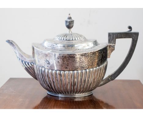 A late Victorian silver tea pot, plain urn-shaped body and spout with fluted section in the Neo-Classical style, the hinged c