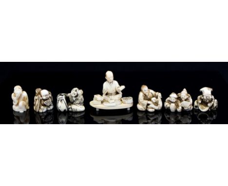 A parcel of assorted Japanese ivory okimono and netsuke, Meiji period 1868-1912, including an okimono of a man seated with a 