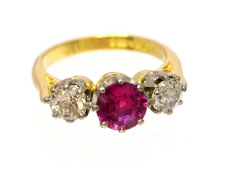 A ruby and diamond three stone ring, the central round mixed cut  ruby weighing approx 1.0 carat, two round old cut diamonds,