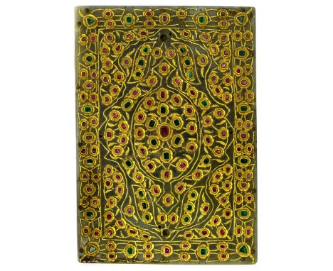 A Middle Eastern gilt metal plaque set with rubies and emeralds, gold inlay of flower head and leaf design, comprising native