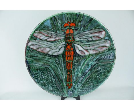 A Poole Pottery Studio charger by Tony Morris depicting a single Dragonfly with outstretched wings with green glazed backgrou