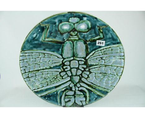 A Poole Pottery Studio charger by Tony Morris depicting a single Dragonfly with outstretched wings in shades of green glaze, 