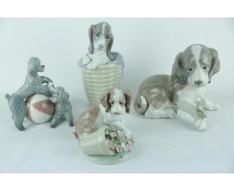 Lladro 'Dog in Basket' 01001128, 'Playing Poodle (Red Ball)' 01001258 and 2 LLadro Puppies. Condition - Unboxed Good Overall 