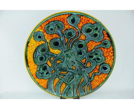 A Poole Pottery Studio charger by Tony Morris depicting multiply seed pods in orange glazed background, marks to base D14, 41