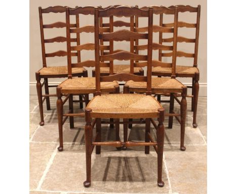 A set of six oak Lancashire ladder back dining chairs, late 19th/early 20th century, each with four shaped rungs over an enve