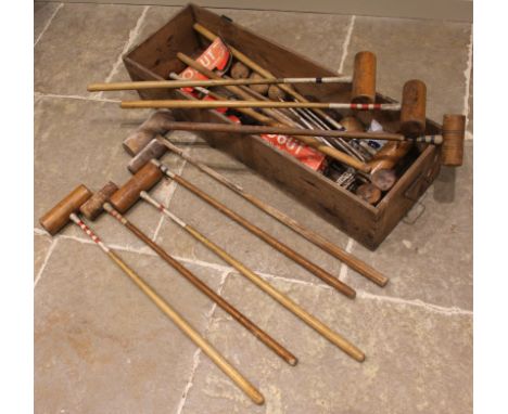 A vintage croquet set, to include twelve assorted mallets, iron hoops and balls, along with carpet bowls, all to a pine box a