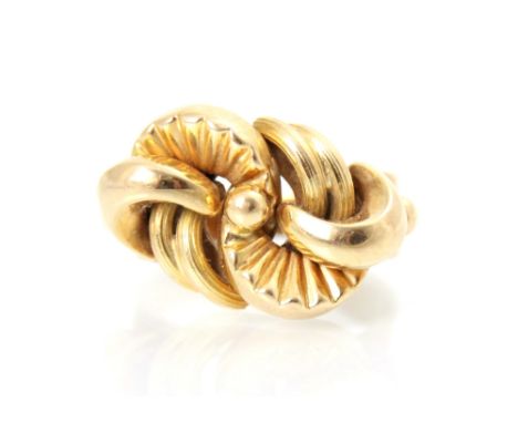 A yellow metal dress ring, the stylised lobed head with textured and plain polished detail, leading to grooved shank, ring si