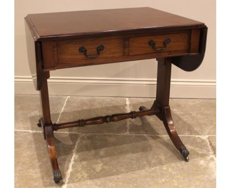 A Regency style mahogany sofa table, mid 20th century, the rectangular drop leaf top with rounded corners over a pair of frie