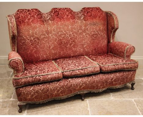 A Queen Anne Revival lounge suite, early 20th century, in embossed foliate fabric, comprising; a three-seater sofa with tripl