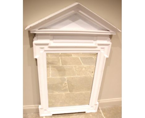 A painted wall mirror in the manner of William Kent, of architectural form, the moulded frame with angular and projected corn