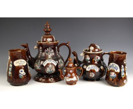 A selection of Bargeware, 19th century and later, each piece treacle glazed, applied with relief moulded floral and foliate m