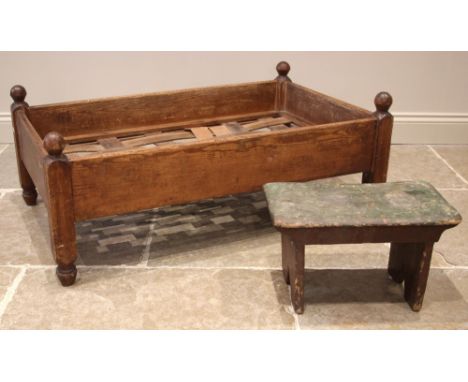 A 19th century pine child's bed frame, each corner post with a spherical finial, united by plain side rails, 43cm H x 110cm W