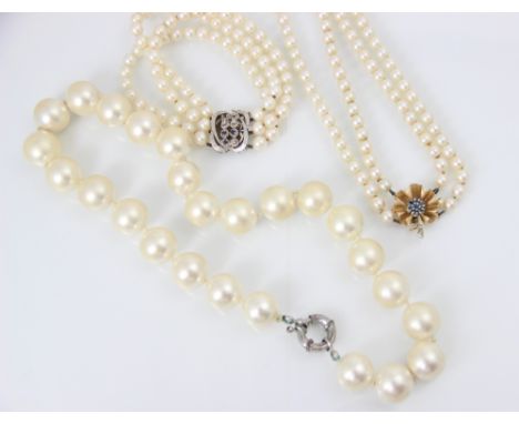 A cultured pearl bracelet, with three rows of uniform pearls of spherical form, with a white metal and untested sapphire and 