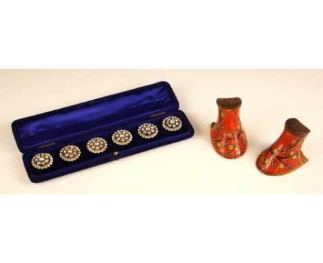 A cased set of 20th century paste set buttons, the stylised flower head designed button with closed back to reverse, with a p