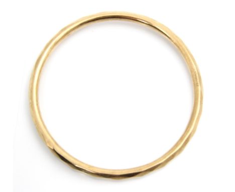 A 9ct yellow gold bangle, the hollow bangle with faceted detail to exterior, stamped Chester 1928, 9gms Condition report:  Th