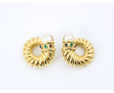 A pair of yellow metal earrings, the stylised swirl earrings with paste pearl terminals and blue, red and green cabochon ston
