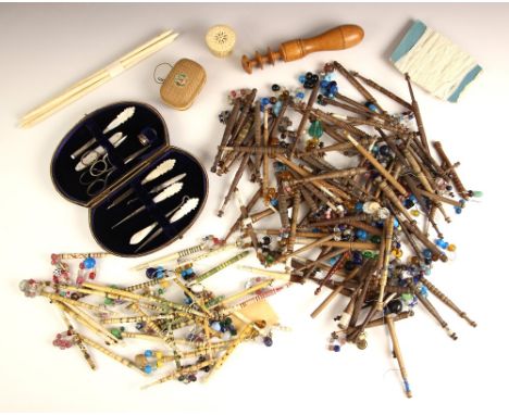 A collection of bone and wooden lace bobbins, 19th century and later, to include decorated examples, each metal wired, decora