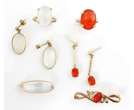 A suite of untested fire opal jewellery, including a 9ct yellow gold dress ring set with an oval cut red stone, ring size M, 