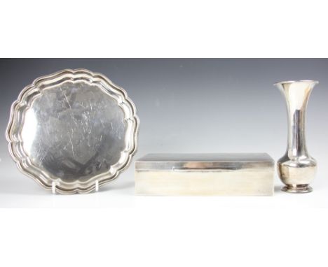 A George V silver waiter, Birmingham 1921, the shaped stepped rim over plain polished bowl, upon three compressed ball feet, 