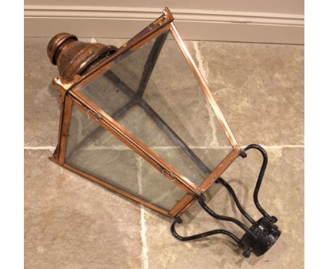 A Victorian copper framed street lantern, of typical square section tapering form, with a domed chimney/finial and leafy span