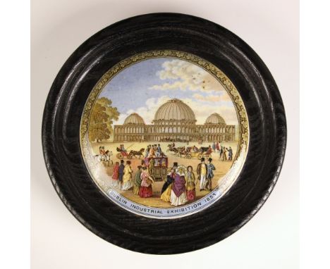 A 'Dublin Industrial Exhibition 1853' Prattware pot lid, mid 19th century, set to an ebonised wooden frame, 17cm diameterCond