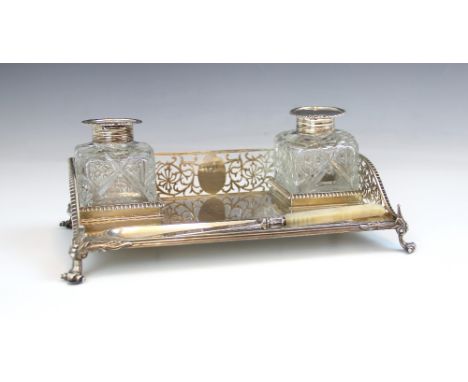 A Victorian silver desk stand, Charles Stuart Harris, London 1892, of rectangular form with pierced floral three quarter gall