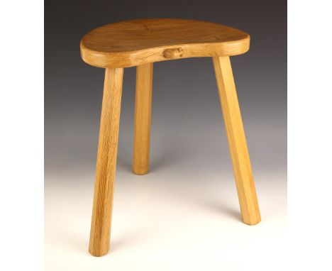 Workshop of Robert "Mouseman" Thompson of Kilburn, a carved oak 'Cow' stool, the reverse tapering octagonal legs jointed to a