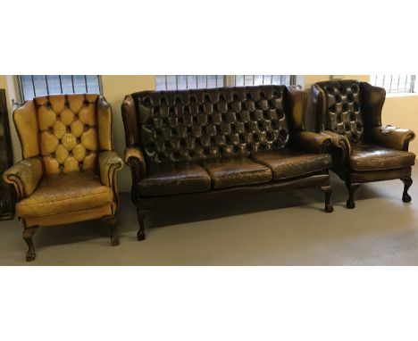 A vintage leather 3 piece suite. Comprising 3 seater settee and 2 wingback chairs all with claw and ball feet. For restoratio