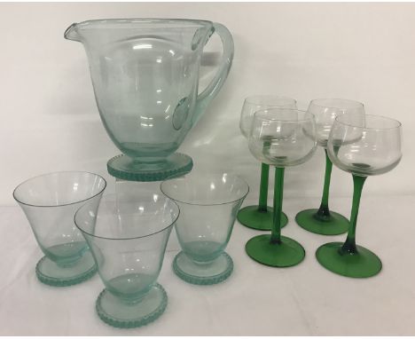 A vintage mint green water jug and 3 matching glasses together with 4 green stemmed hock glasses.  