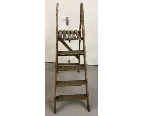 A vintage 5 tread wooden step ladder.  