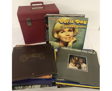 A collection of assorted vintage vinyl LP's and box sets together with a red record case. Records to include: Abba, Neil Diam
