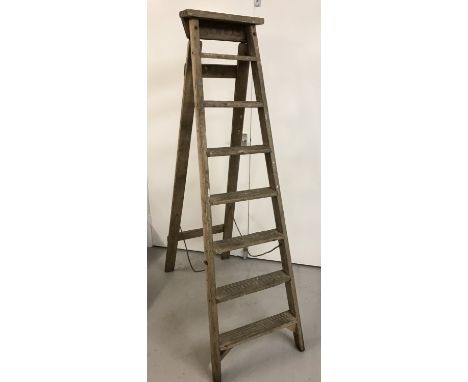 A vintage 8 tread wooden step ladder.  