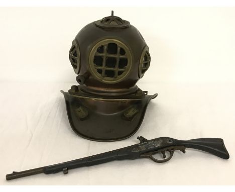 A vintage brass model of a replica divers helmet together with a Sharps 1859 model rifle. Rifle marked "Made in Spain", made 