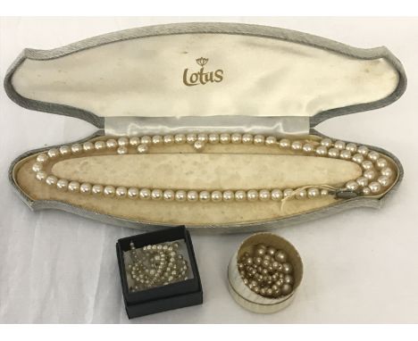 A vintage cased Lotus double string pearl necklace (in need of repair). Together with 2 other vintage pearl necklaces, also i