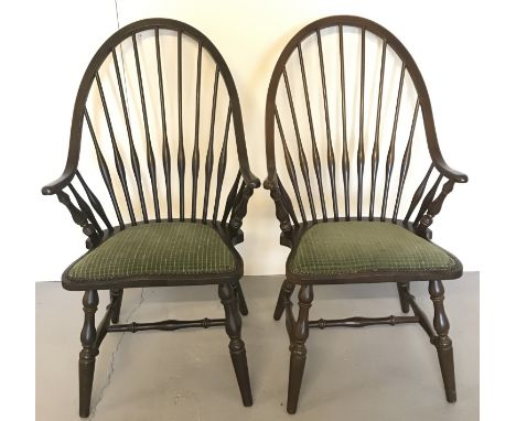 A pair of large hoop stick back chairs. Upholstered in green, with arm rests and turned legs. Approx. 100cm tall.