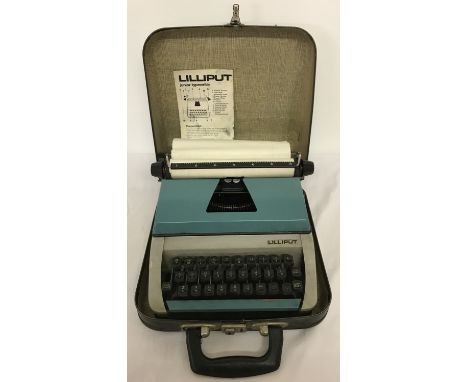 A vintage Lilliput junior typewriter, complete with lockable carry case and instructions.  