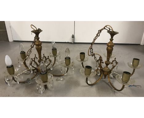 A pair of vintage brass and glass drop 5 arm ceiling lights. Classic decoration to brass body. Height approx. 33cm each.