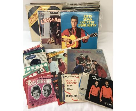 A box of assorted vintage records comprising 7", 12" and LP's. To include: Chas &amp; Dave, Elvis Presley and Neil Sedaka. 