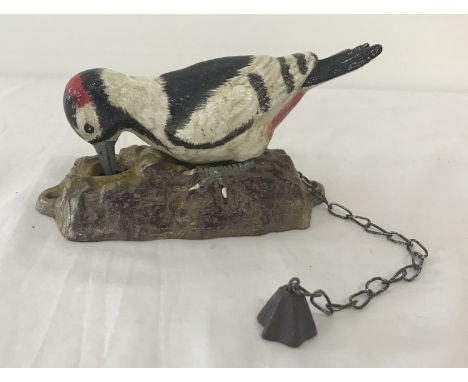 A painted cast metal door knocker on the shape of a woodpecker with fixing holes. Complete with chain pull. Total height (wit